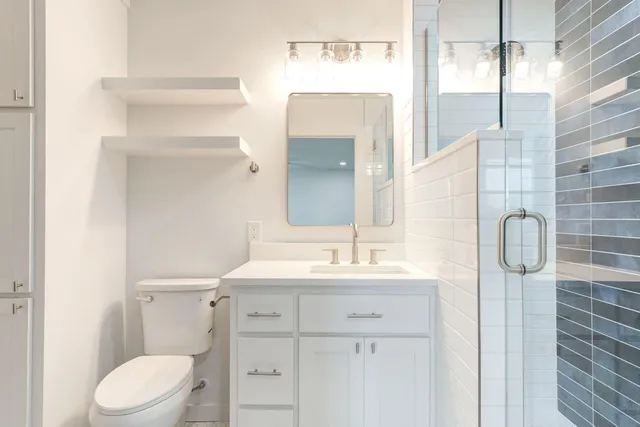 an empty room with closet and windows