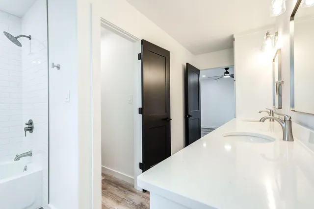 a bathroom with a double vanity sink and mirror