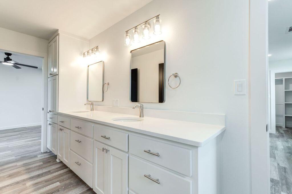 6601 North C R 1500 Shallowater, TX 79363 - Photo 34 of 39 a bathroom with a double vanity sink and mirror