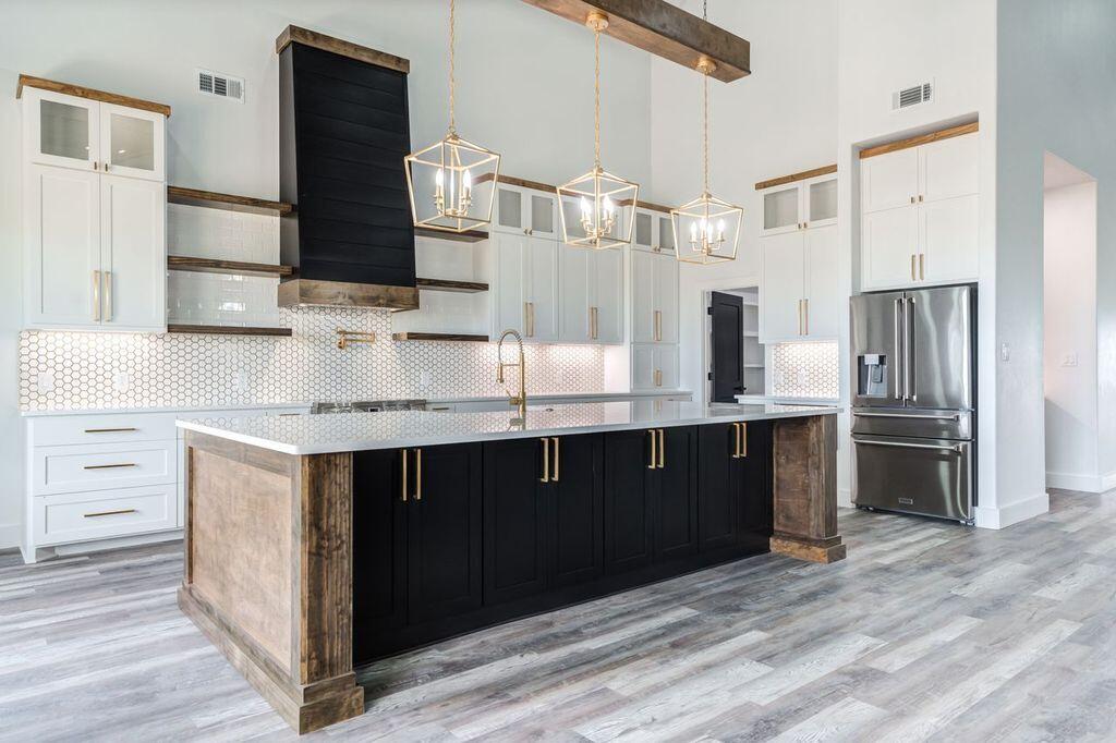 6601 North C R 1500 Shallowater, TX 79363 - Photo 5 of 39 a kitchen with stainless steel appliances kitchen island granite countertop a refrigerator and a sink