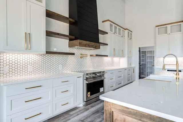 a kitchen with granite countertop white cabinets and white appliances