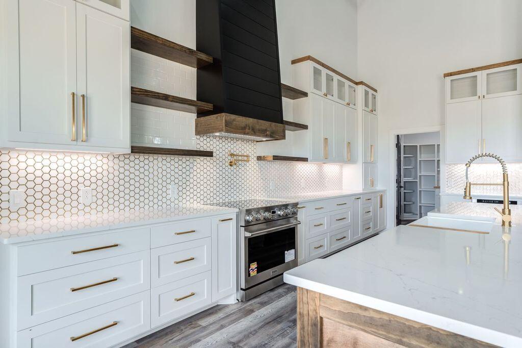 6601 North C R 1500 Shallowater, TX 79363 - Photo 6 of 39 a kitchen with granite countertop white cabinets and white appliances