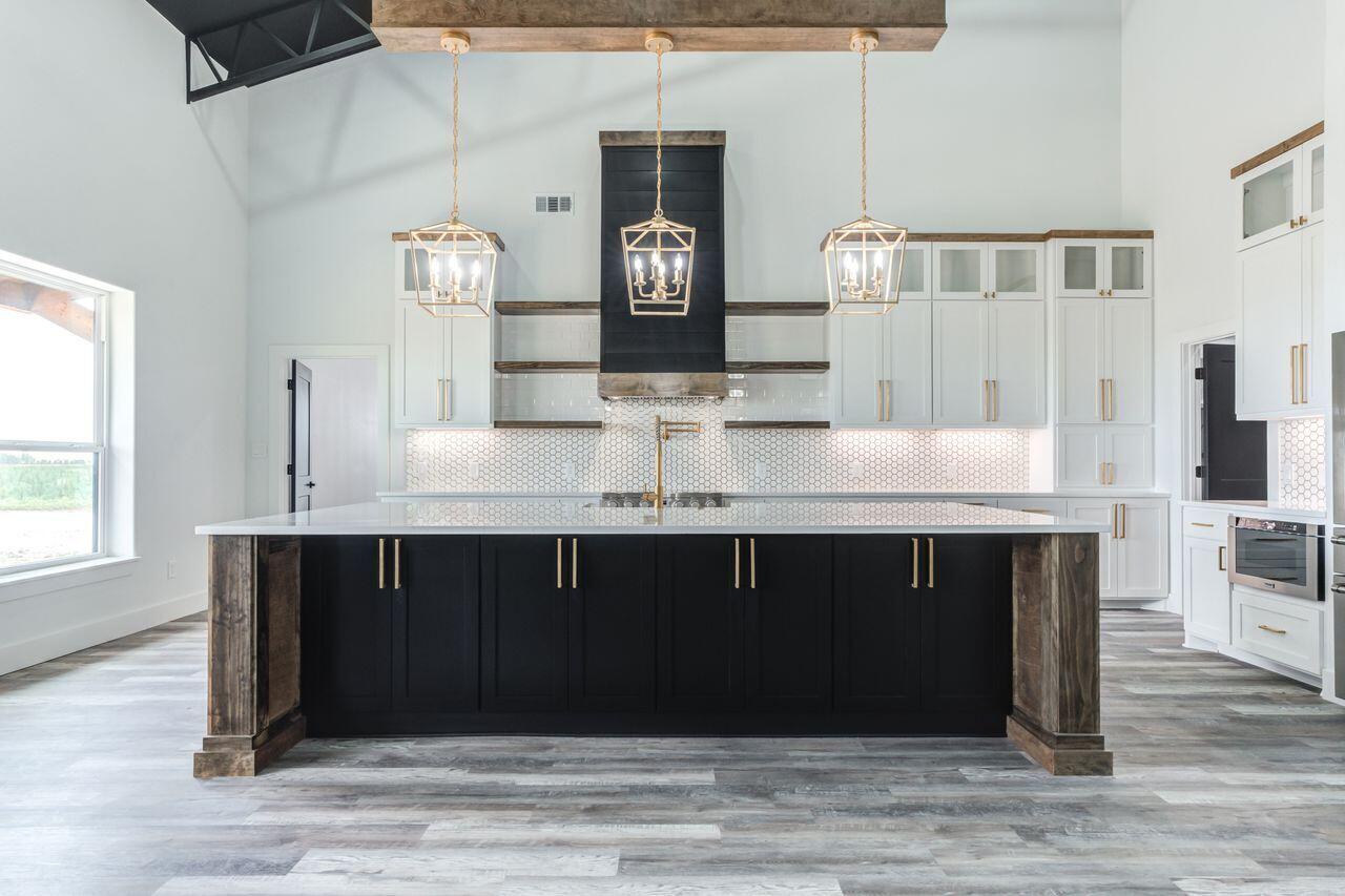 6601 North C R 1500 Shallowater, TX 79363 - Photo 9 of 39 a kitchen with a cabinets and wooden floor
