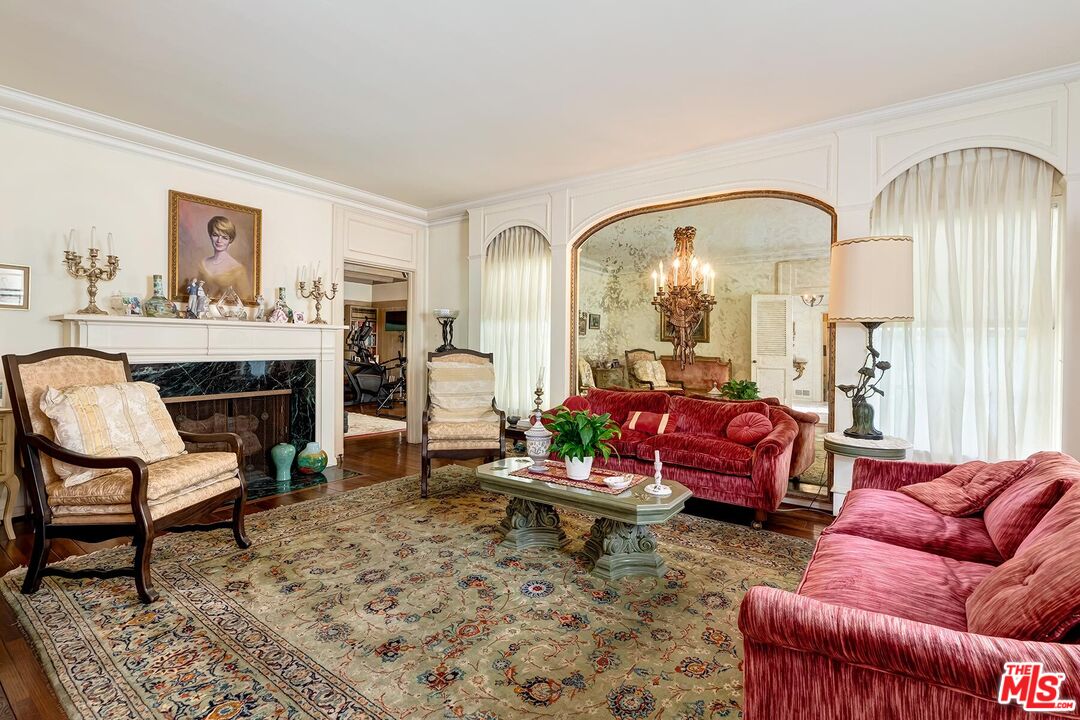 710 North Beverly Drive Beverly Hills, CA 90210 - Photo 12 of 18 a living room with furniture a rug and a fireplace