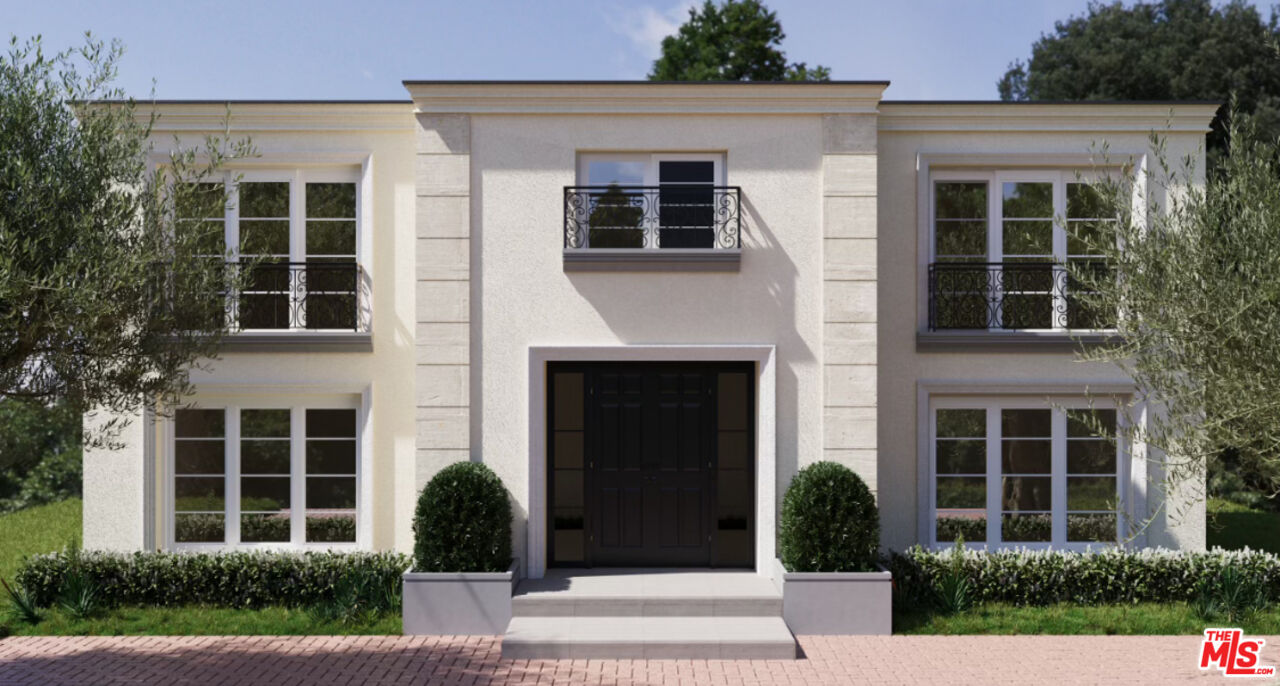 710 North Beverly Drive Beverly Hills, CA 90210 - Photo 17 of 18 a front view of a house with a yard