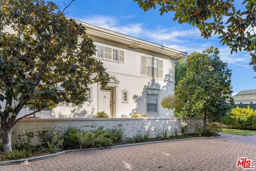 710 North Beverly Drive Beverly Hills, CA 90210 - Photo 3 of 18 a front view of a house with a yard