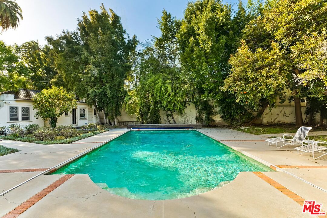 710 North Beverly Drive Beverly Hills, CA 90210 - Photo 8 of 18 a view of a swimming pool with a patio