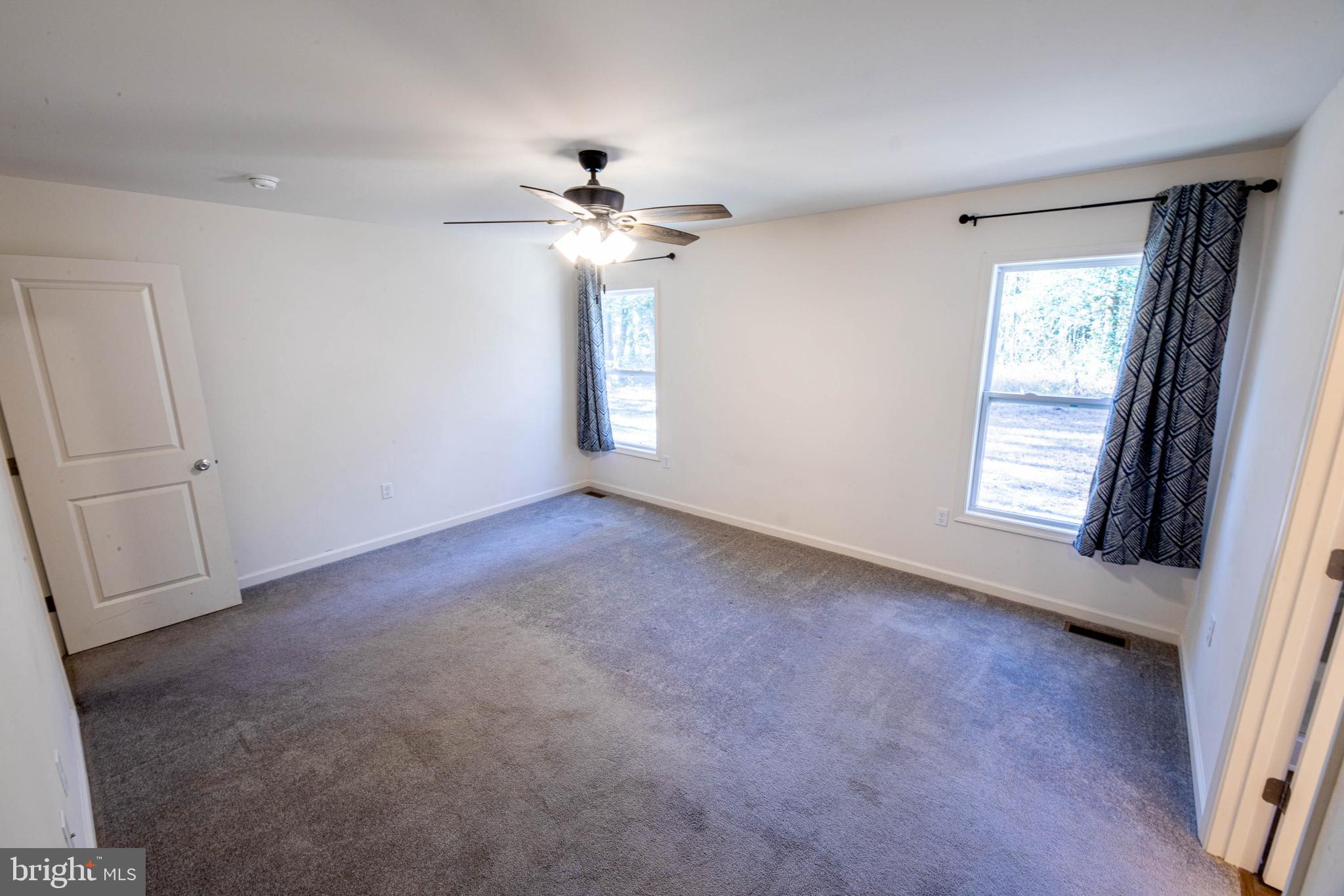 26300 Fire Tower Road Seaford, DE 19973 - Photo 20 of 52 an empty room with windows and fan