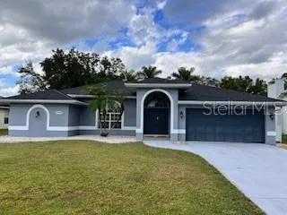 a front view of a house with yard and garage