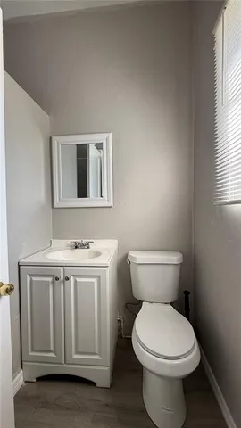 a bathroom with a sink a toilet and a window