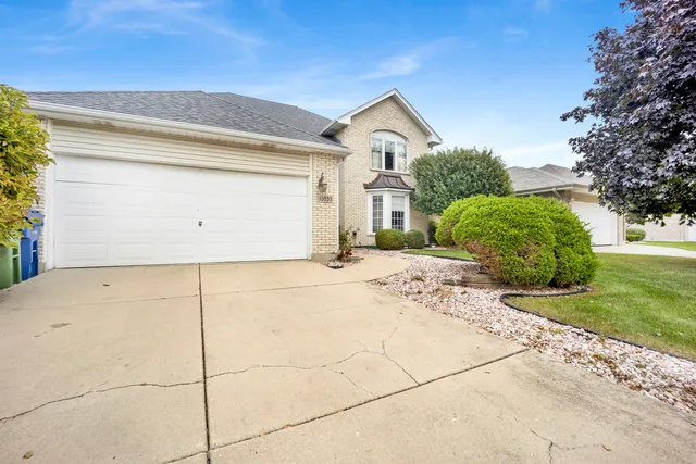 a view of a house with a yard and garage