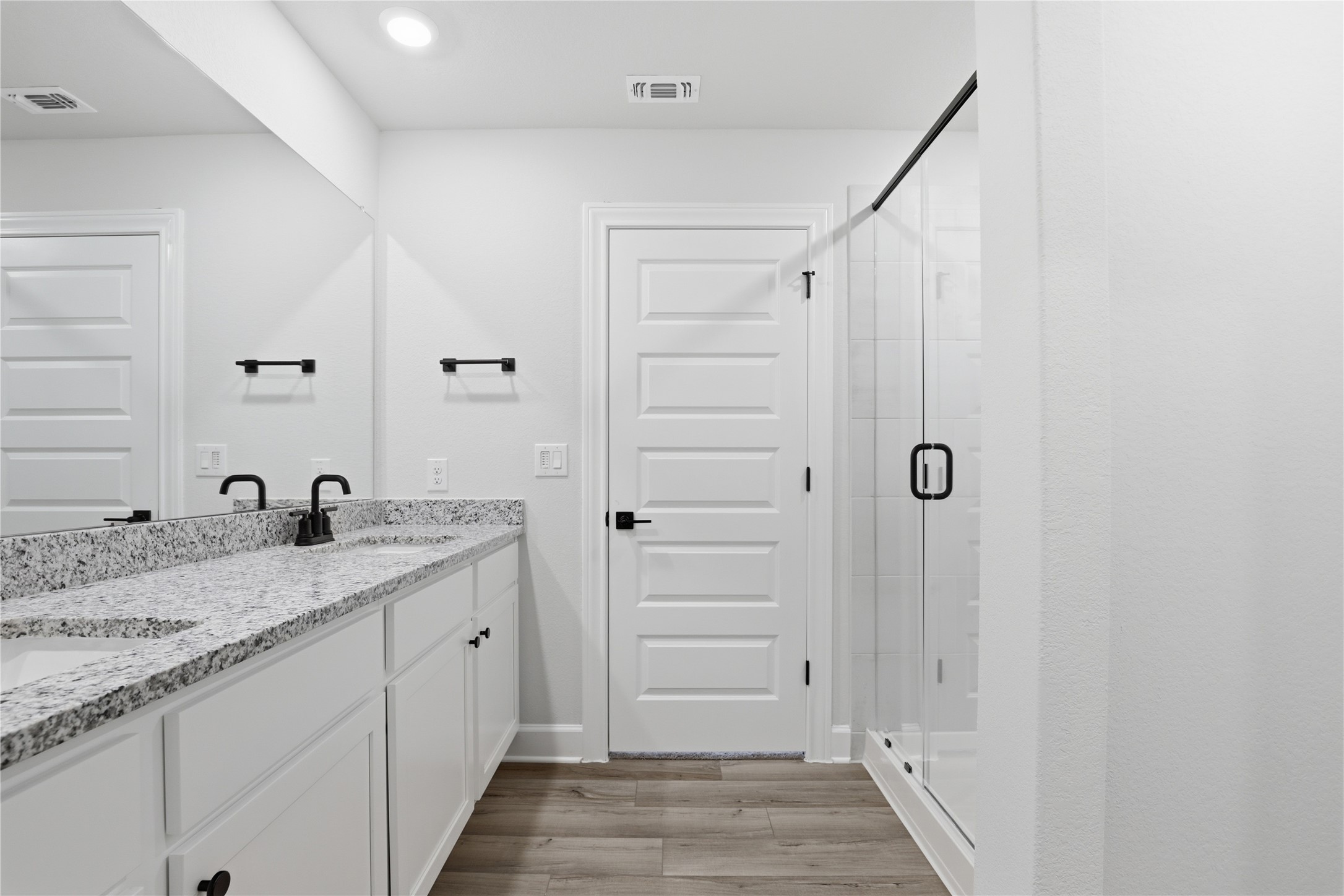 9320 Gladsome Path Manor, TX 78653 - Photo 27 of 34 a bathroom with a granite countertop sink and a mirror