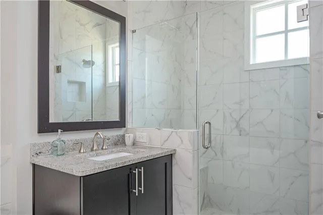 a bathroom with a granite countertop sink and a mirror