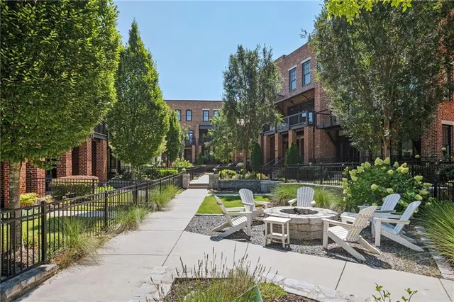 a view of swimming pool with outdoor seating and plants
