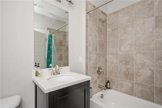 a bathroom with a sink toilet tub and shower