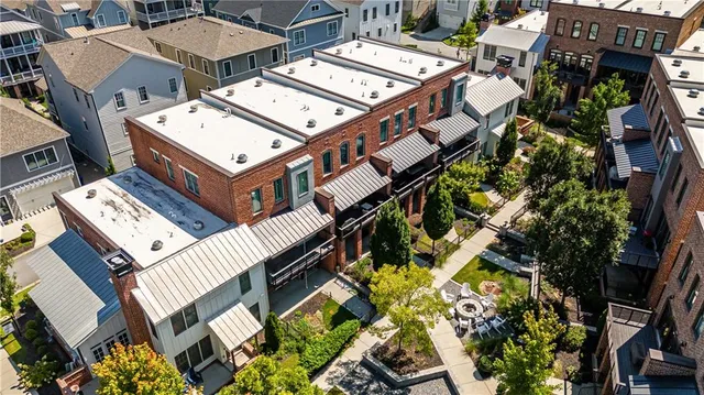 an aerial view of a house with a large tree