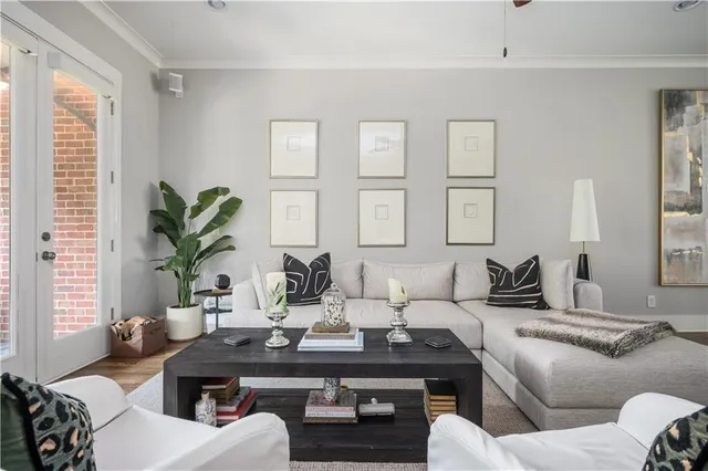 a living room with furniture potted plant and windows