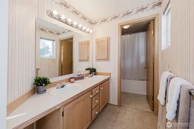 a bathroom with a sink a tub and a mirror