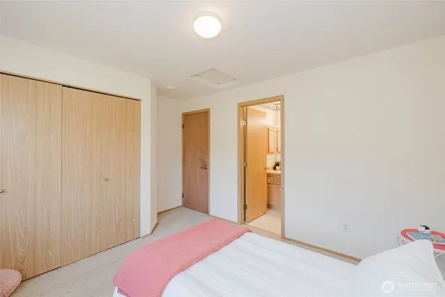 a bedroom with a bed and a closet