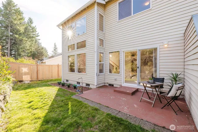 a view of a house with backyard and sitting area