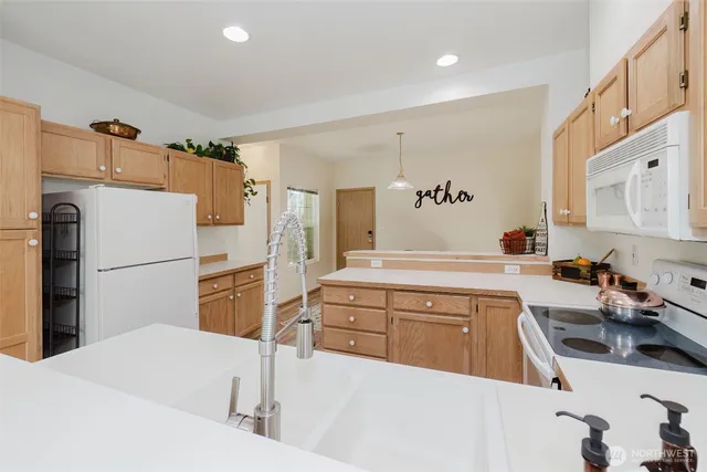 a kitchen with a sink appliances and cabinets