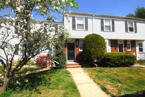 a view of a house with a yard and plants