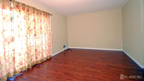 a view of an empty room and wooden floor