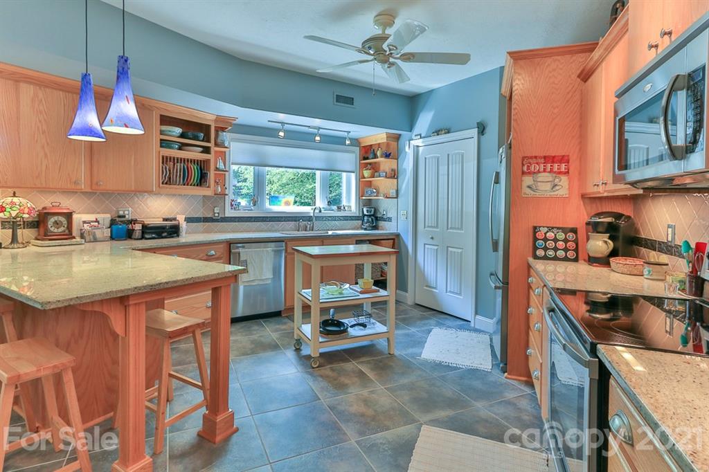 24 Juniper Lane Marion, NC 28752 - Photo 11 of 48 a kitchen with a stove a sink and a refrigerator