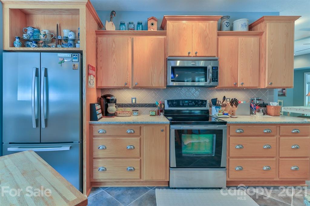 24 Juniper Lane Marion, NC 28752 - Photo 12 of 48 a kitchen with stainless steel appliances granite countertop a refrigerator and a stove top oven