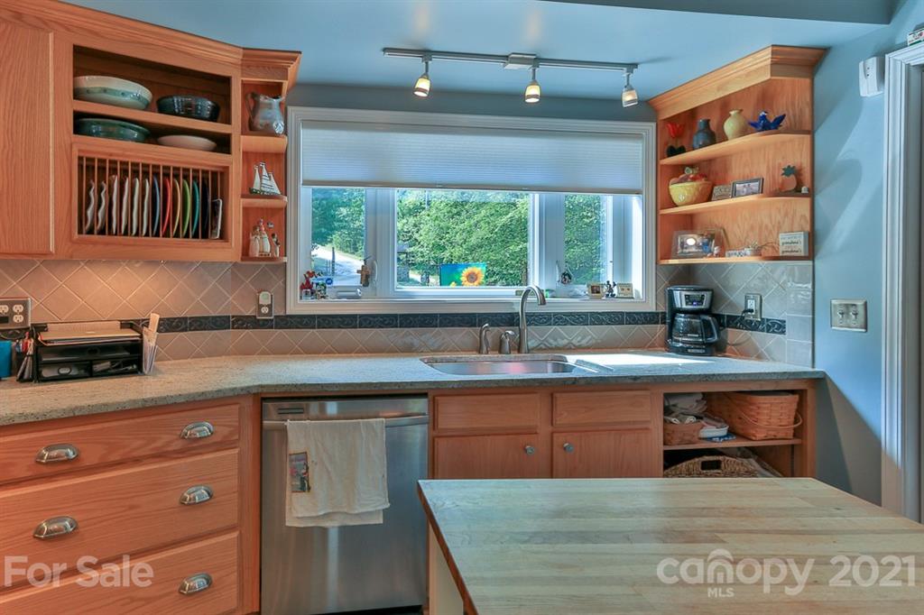 24 Juniper Lane Marion, NC 28752 - Photo 13 of 48 a kitchen with stainless steel appliances granite countertop a stove a sink and a microwave