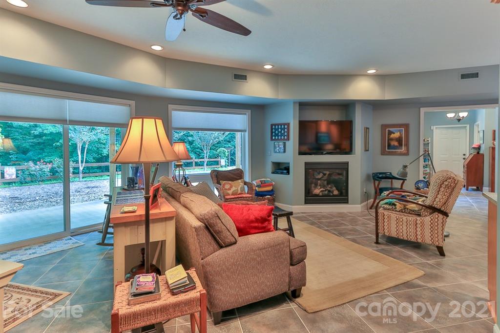 24 Juniper Lane Marion, NC 28752 - Photo 14 of 48 a living room with furniture a fireplace and a flat screen tv