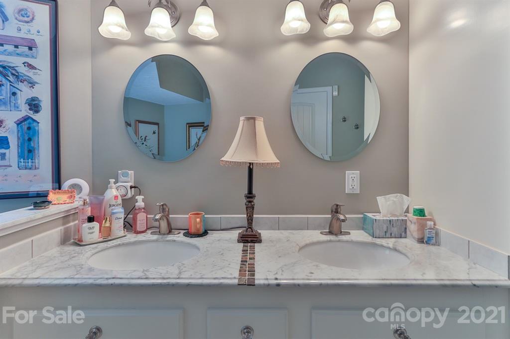 24 Juniper Lane Marion, NC 28752 - Photo 16 of 48 a bathroom with a double vanity sink and a mirror