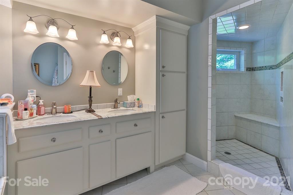 24 Juniper Lane Marion, NC 28752 - Photo 17 of 48 a bathroom with a double vanity sink mirror and shower