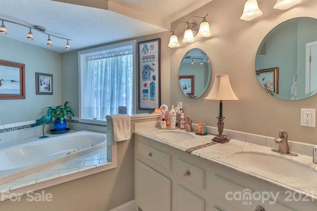 24 Juniper Lane Marion, NC 28752 - Photo 19 of 48 a bathroom with a double vanity sink and a mirror