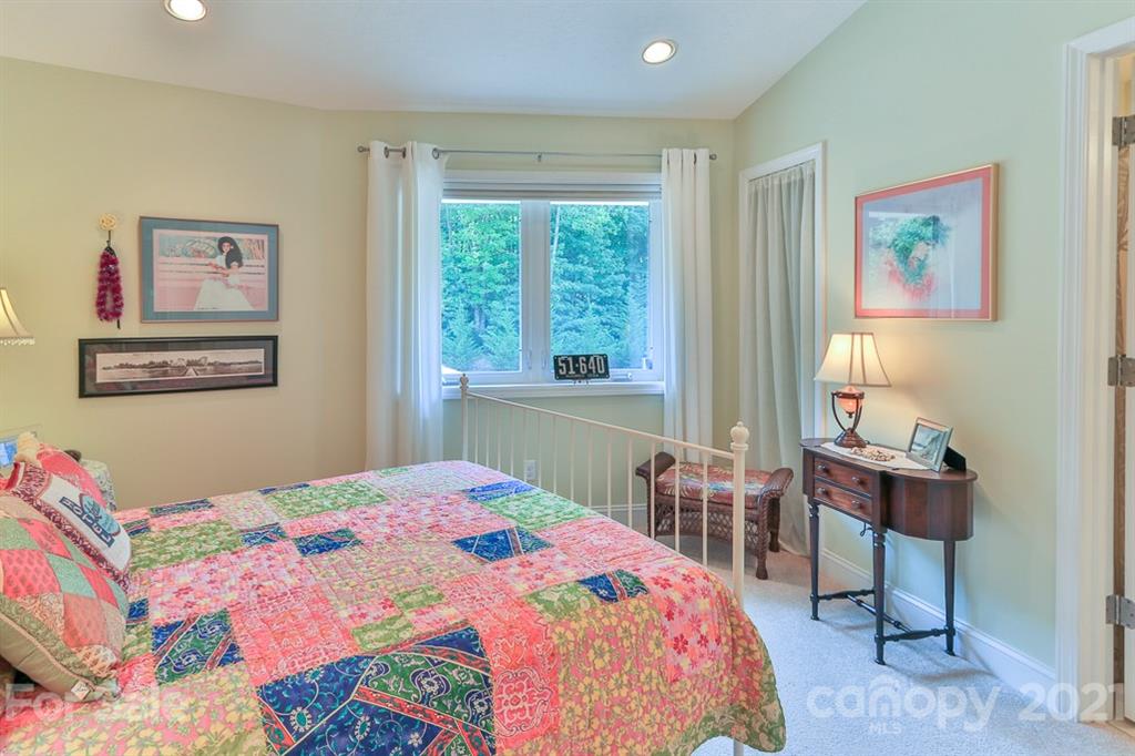 24 Juniper Lane Marion, NC 28752 - Photo 29 of 48 a bedroom with a bed a table and a window