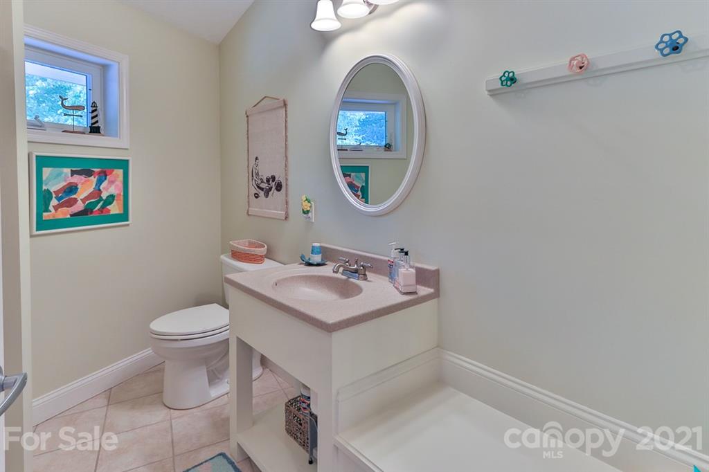 24 Juniper Lane Marion, NC 28752 - Photo 31 of 48 a bathroom with a toilet a sink and a mirror
