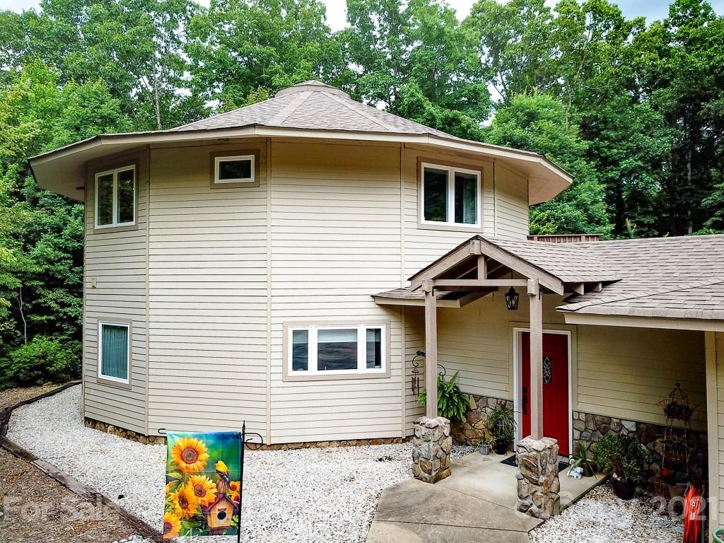 24 Juniper Lane Marion, NC 28752 - Photo 5 of 48 a front view of house with yard outdoor seating and barbeque oven