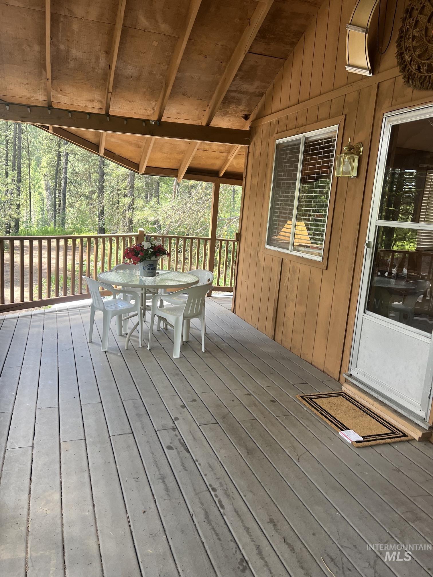 39 Mayflower Mine Road Placerville, ID 83666 - Photo 4 of 36 Expansive covered porch featuring wood-finish decking and wood-paneled siding