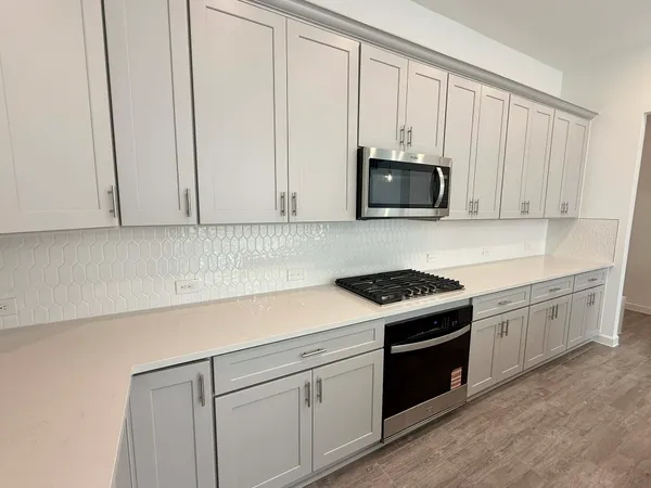 a kitchen with granite countertop sink stainless steel appliances and cabinets