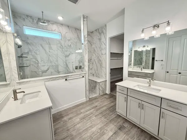 a bathroom with a double vanity sink and mirror