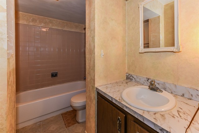 386 Rodenburg Road Roselle, IL 60172 - Photo 14 of 21 a bathroom with a granite countertop sink a toilet and shower