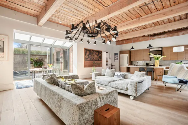 a living room with furniture and a chandelier