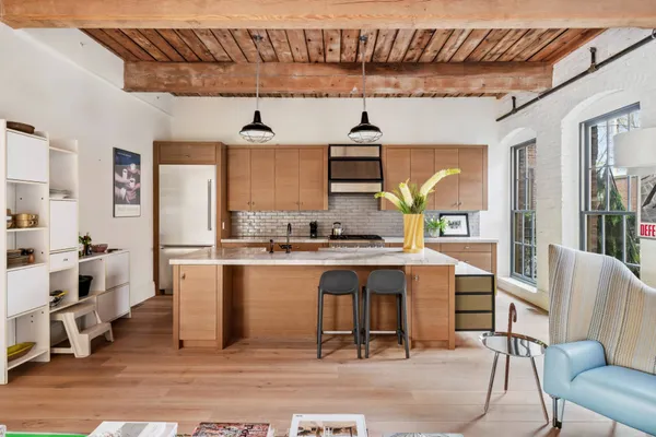 a kitchen with cabinets and chairs