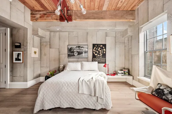 a bedroom with a bed and a window