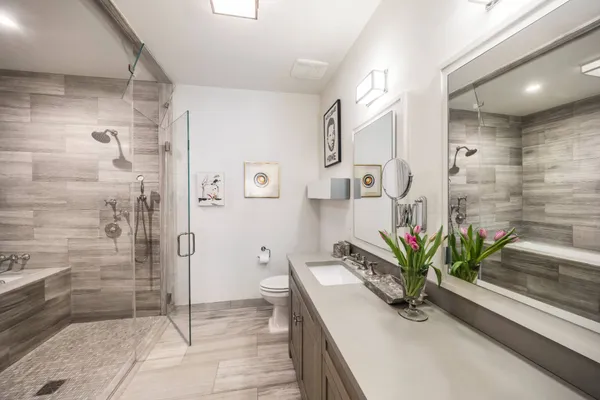 a view of bathroom with a shower and a sink