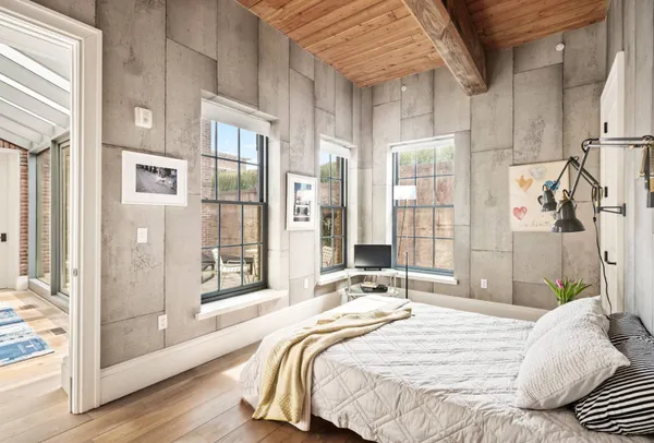 a bedroom with a bed and glass door