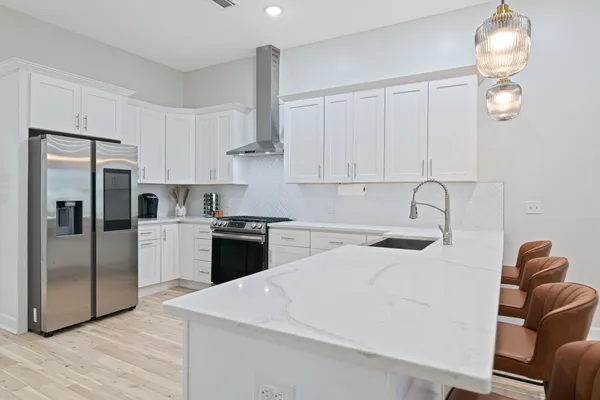 a kitchen with stainless steel appliances a refrigerator sink and cabinets