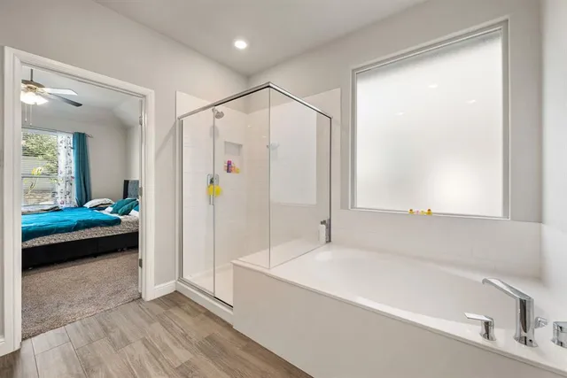 a bathroom with a bathtub and a shower