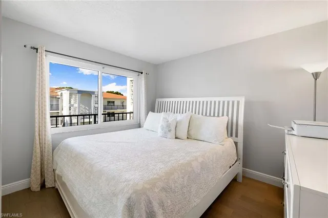 a large bed sitting in a bedroom next to a window