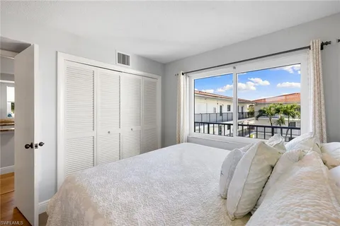 a bedroom with a large bed and a large window